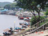 On the river at the golden triangle.  Large flat bottomed boats to carry freight to China and return.